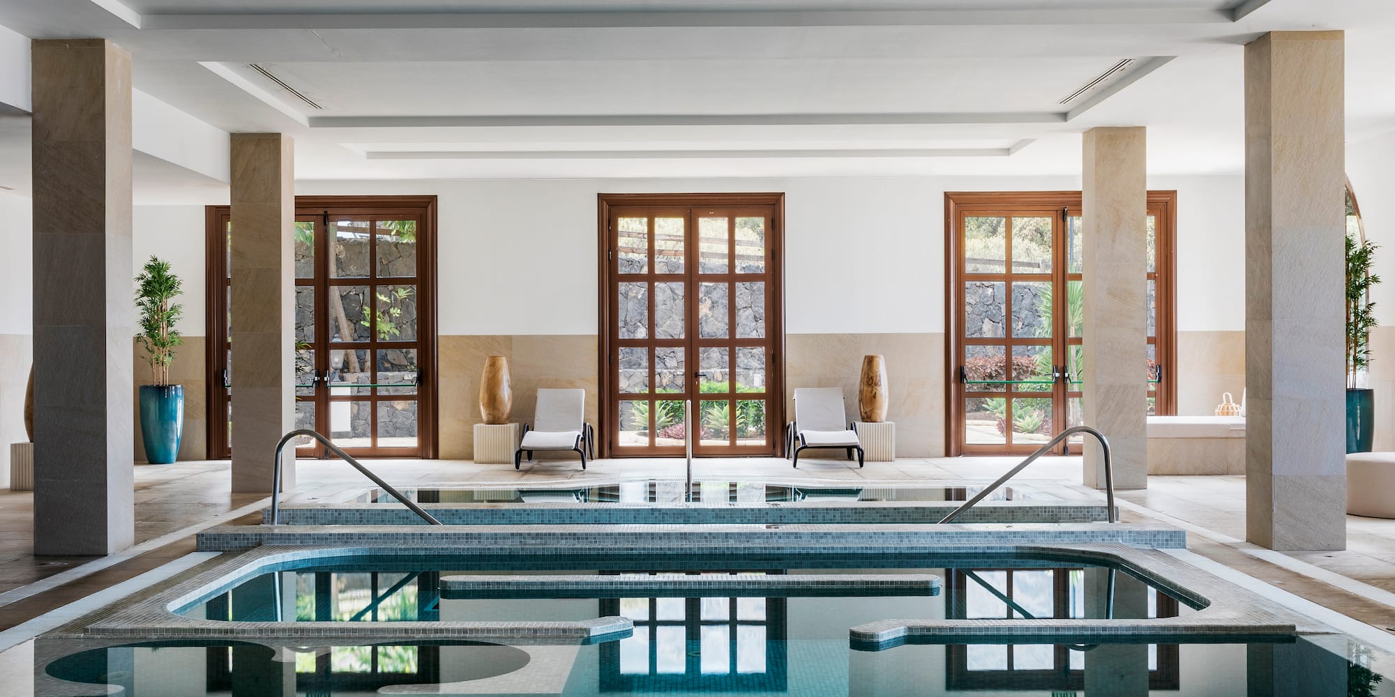 a indoor pool with a large tub