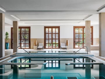 a indoor pool with a large tub