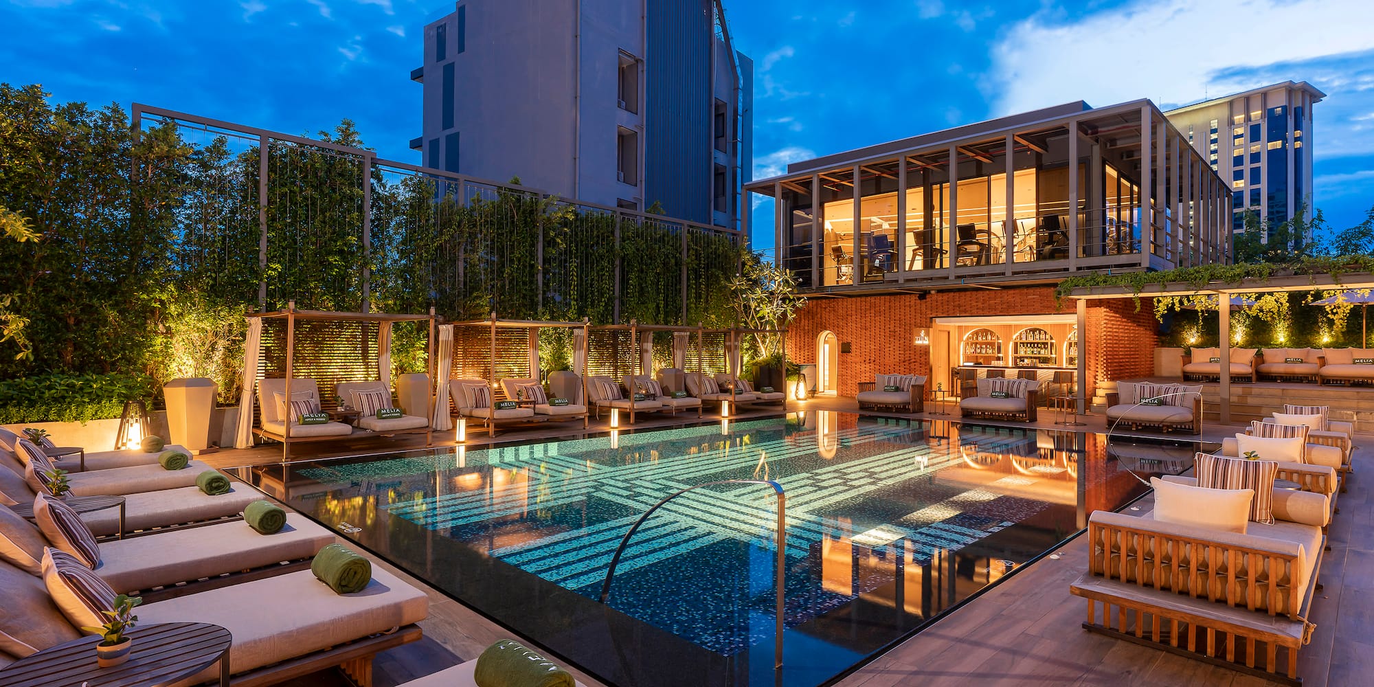 a pool with lounge chairs and a building