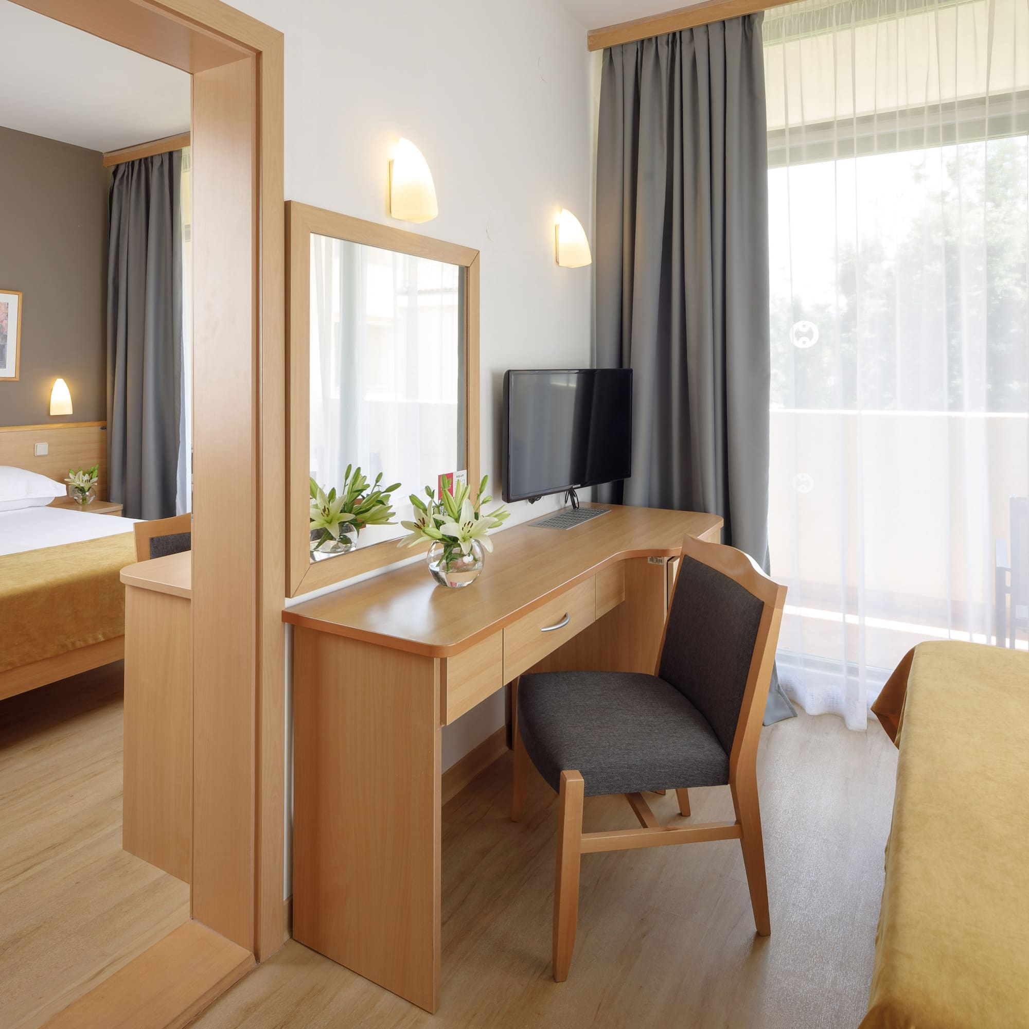 a room with a desk and a mirror