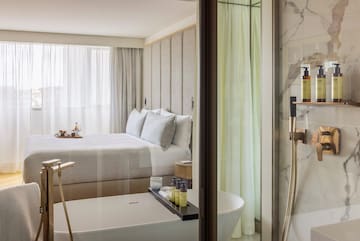 a bathroom with a bed and bathtub