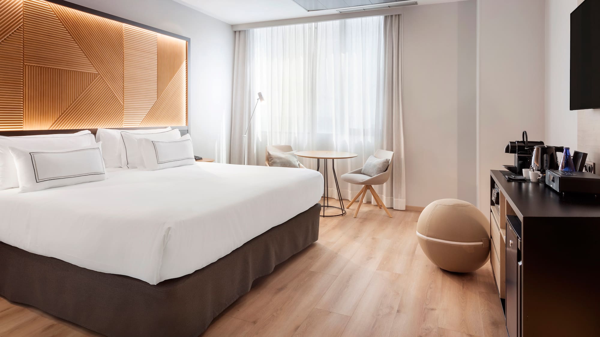 a room with a bed and a television