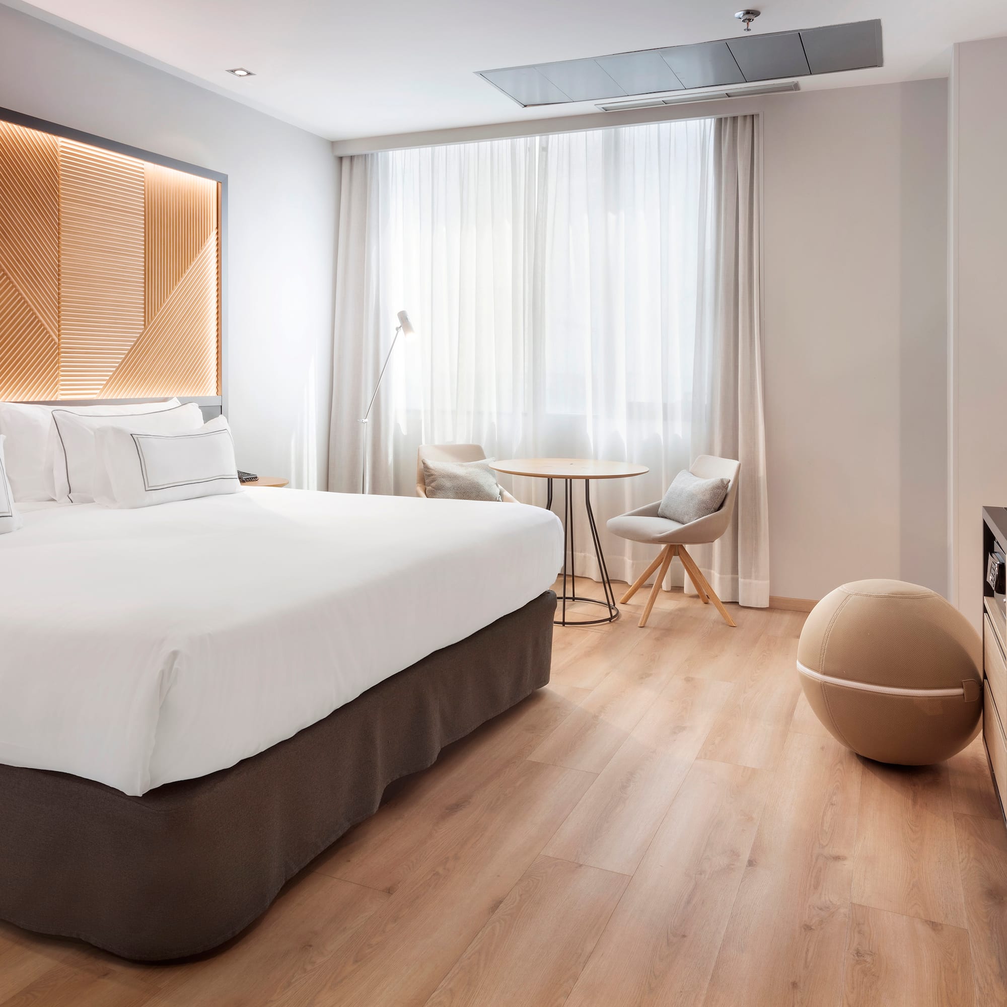 a room with a bed and a television