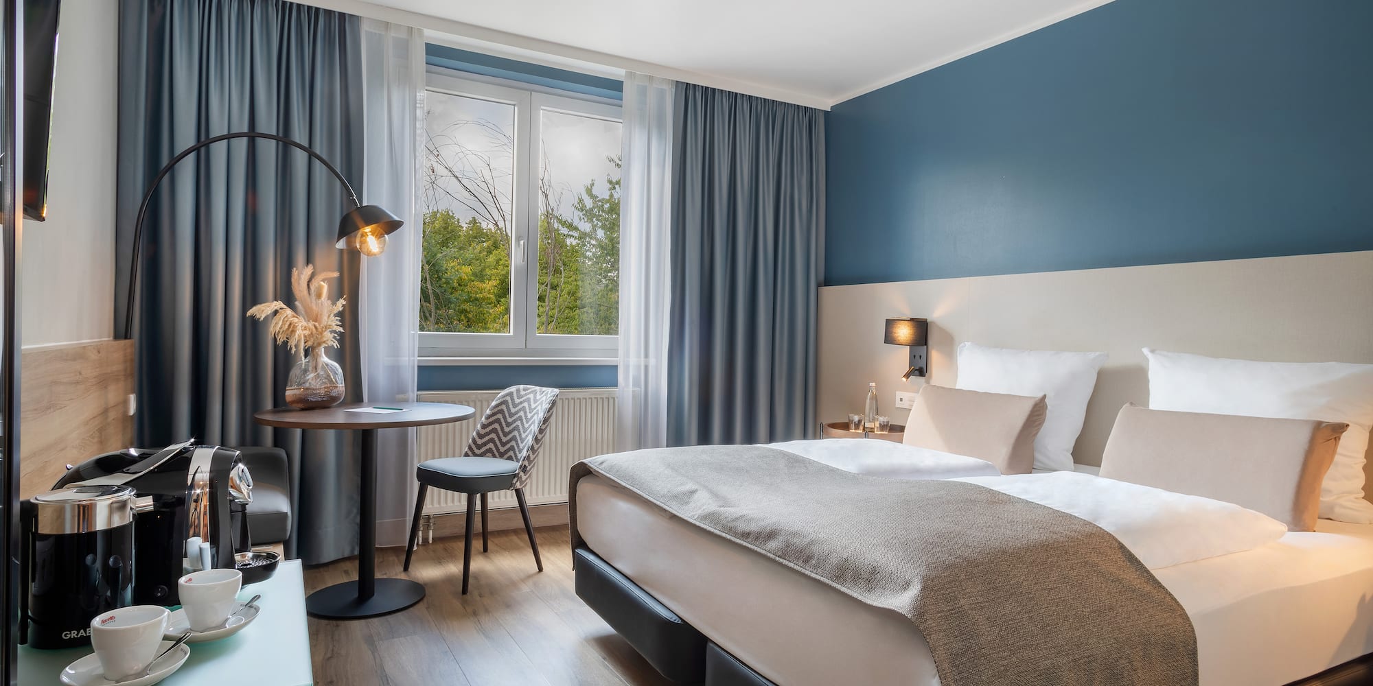 a bedroom with a bed and a table and chair