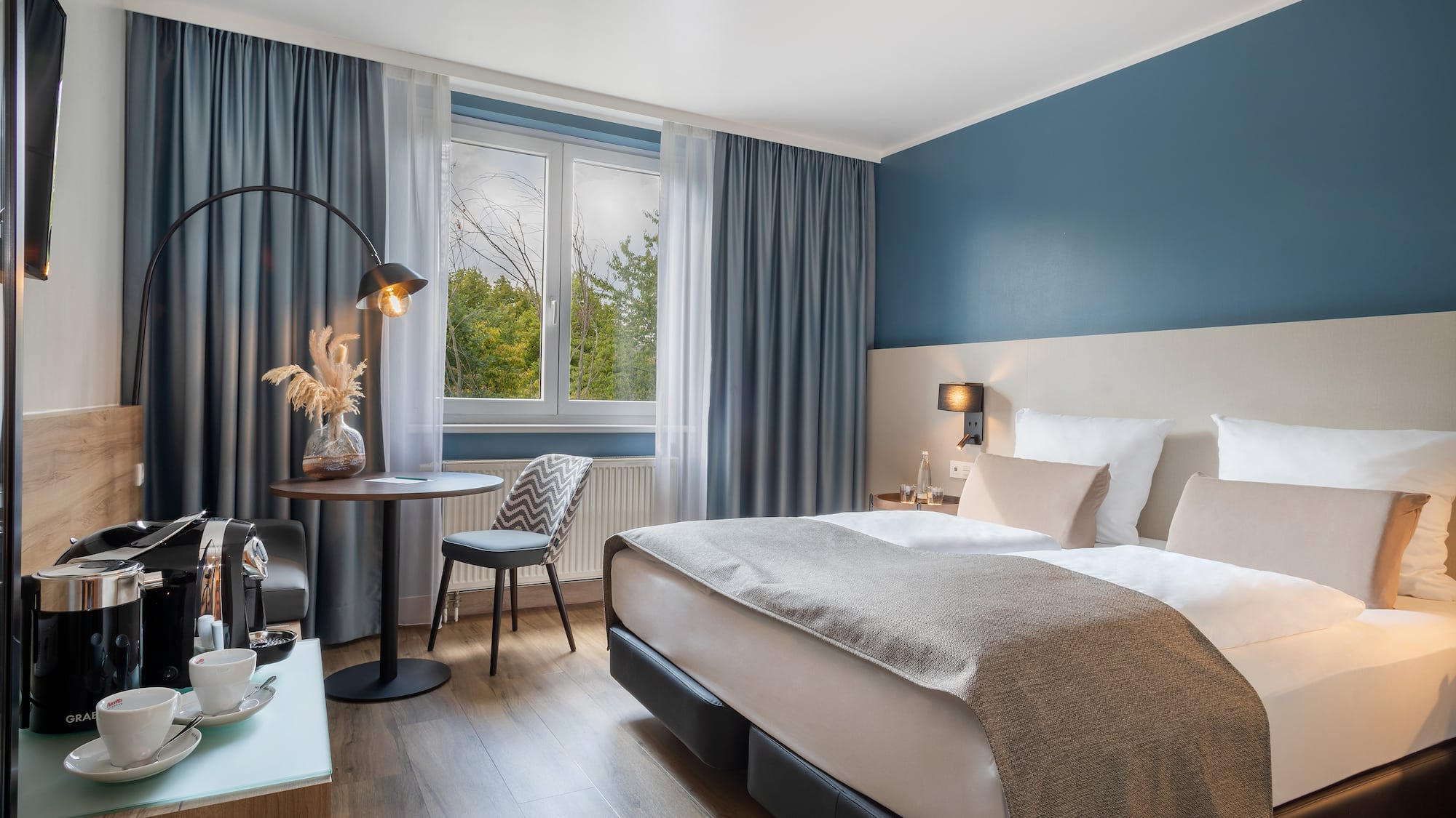 a bedroom with a bed and a table and chair