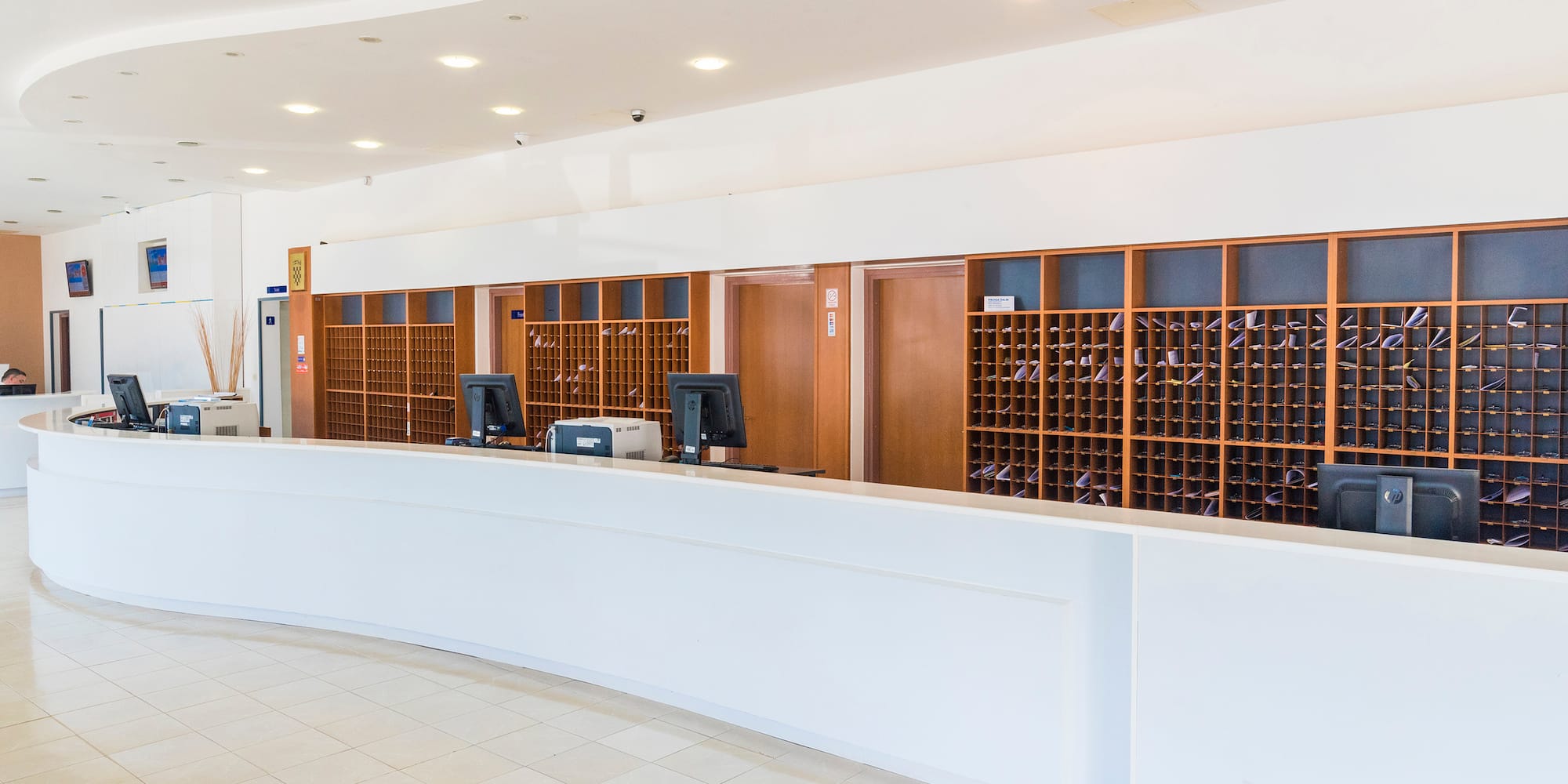 a reception desk with wine bottles in front of it