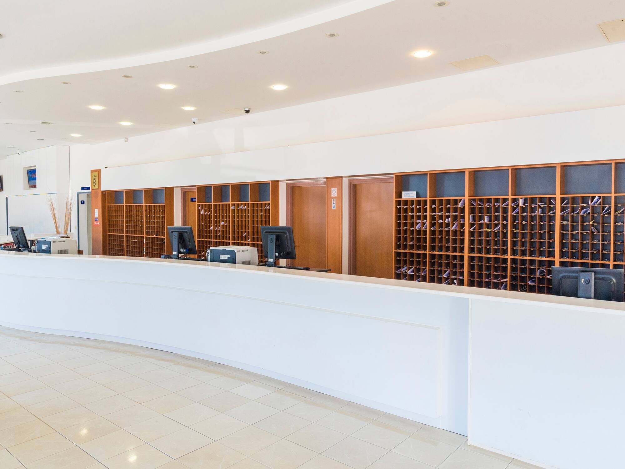 a reception desk with wine bottles in front of it
