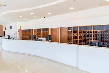a reception desk with wine bottles in front of it