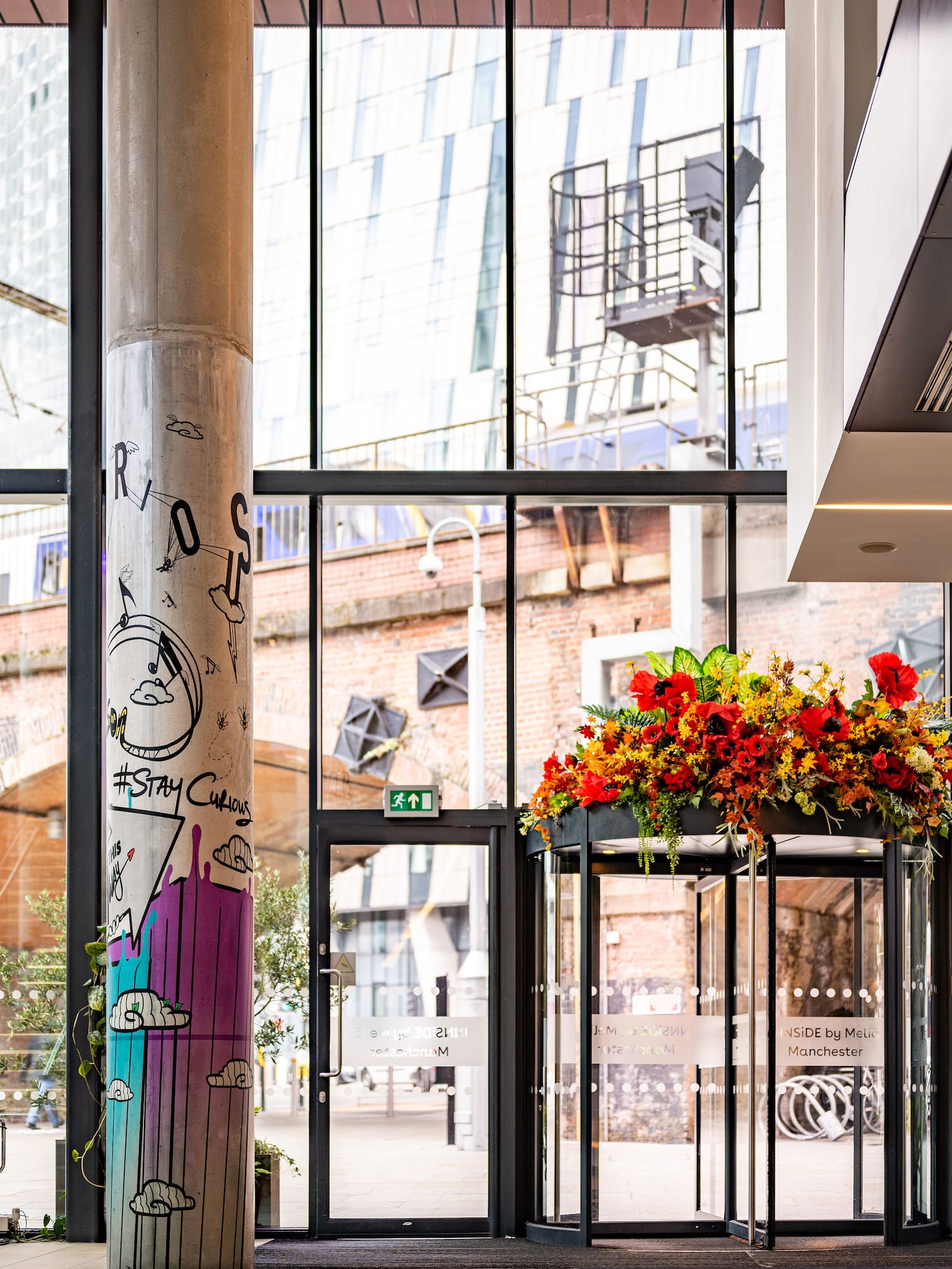 a glass building with a large flower display