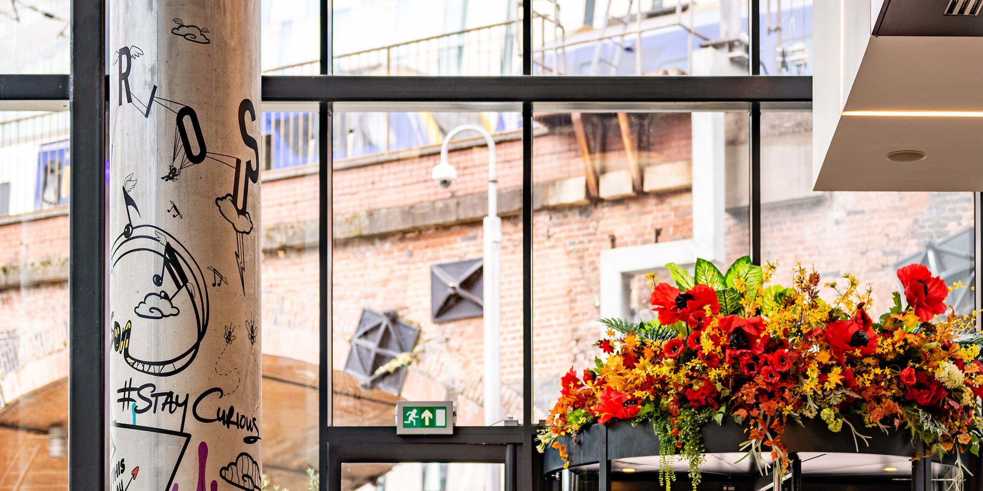 a glass building with a large flower display