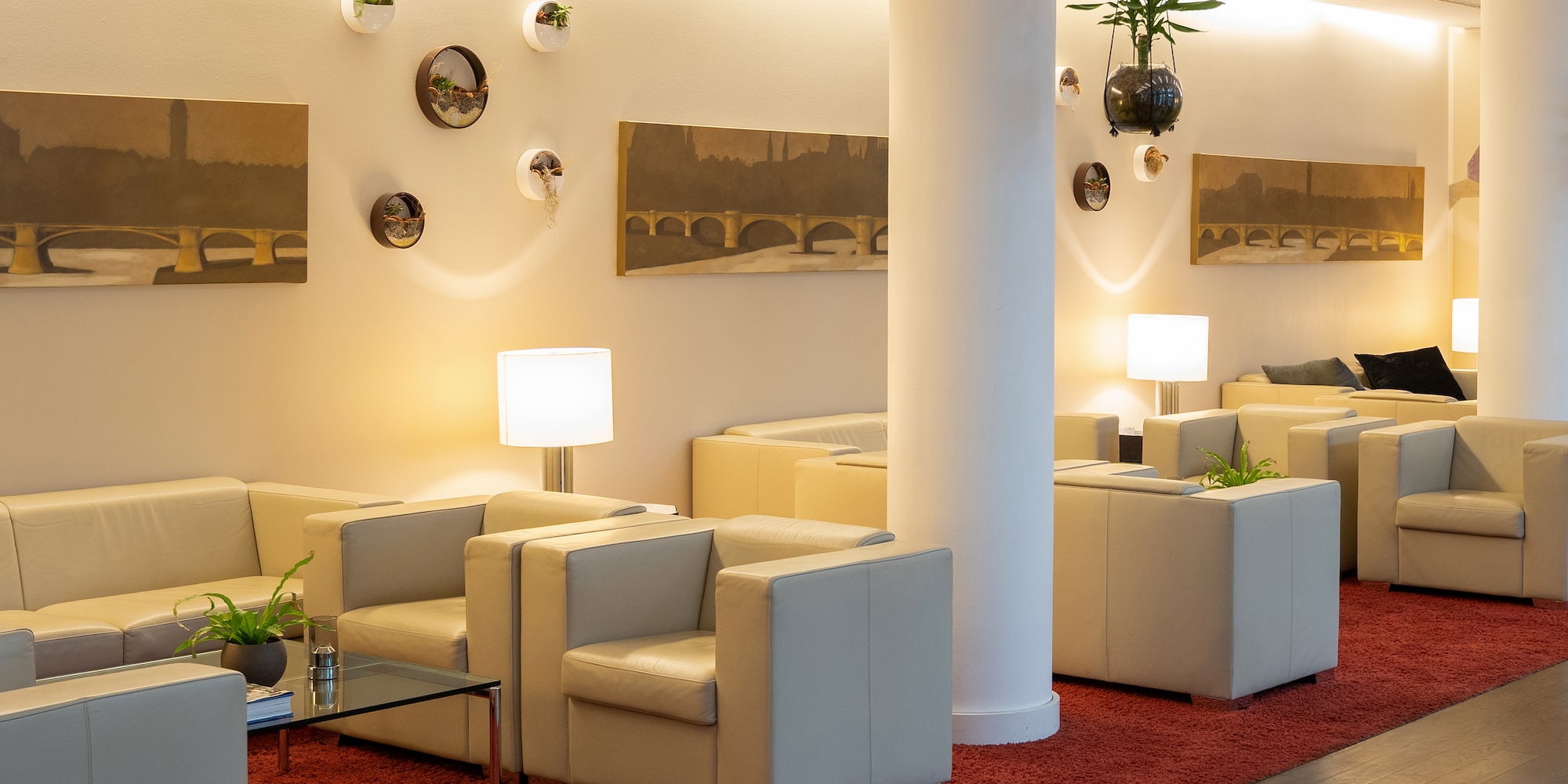 a room with white couches and a red carpet