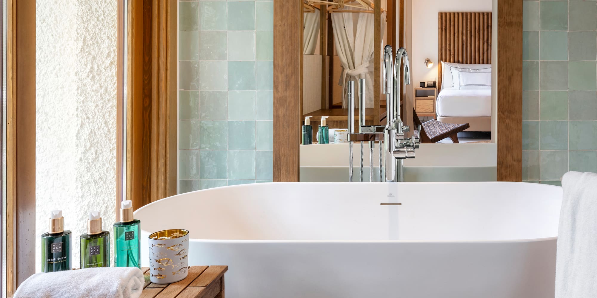 a bathroom with a bathtub and a mirror