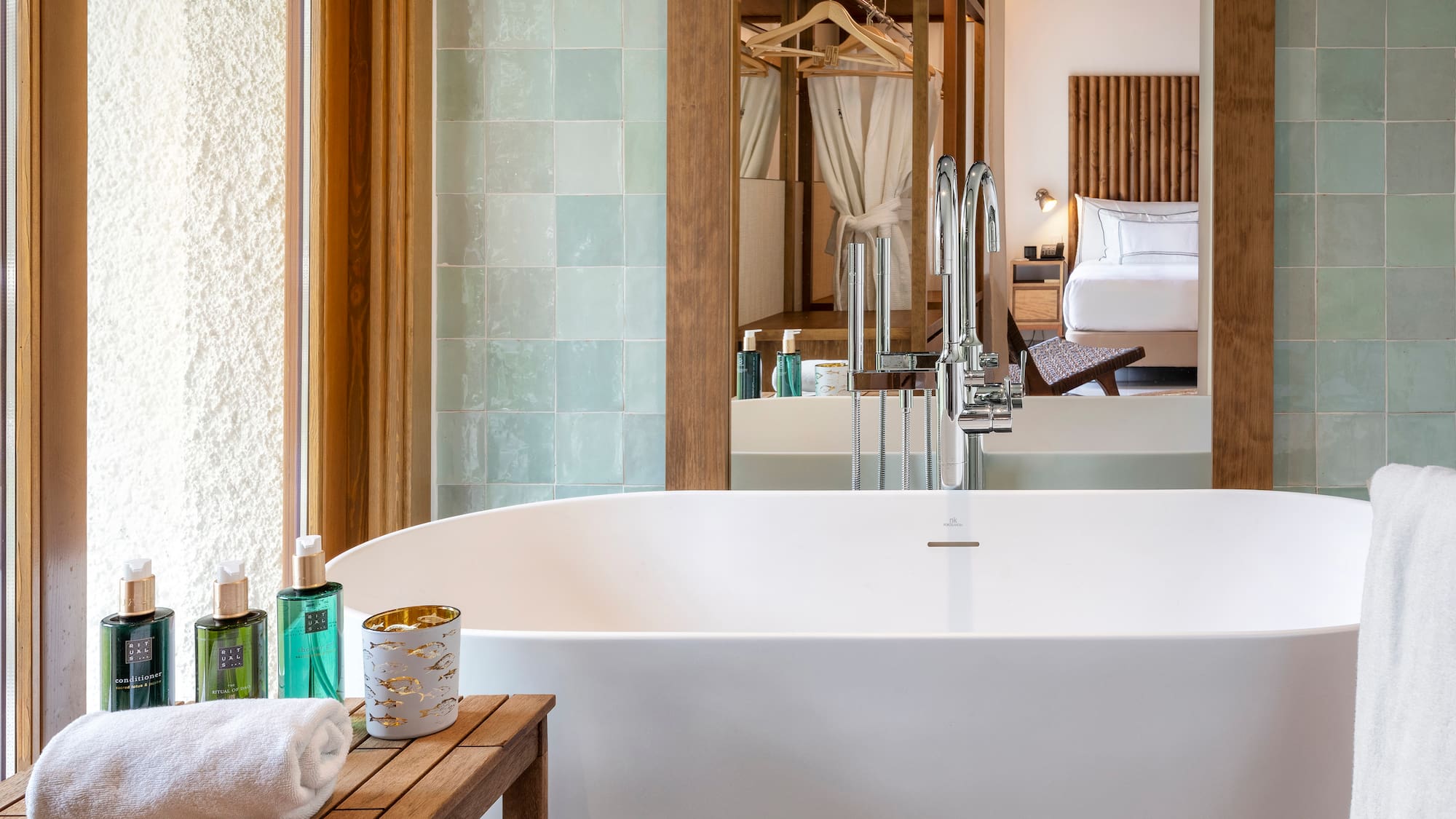 a bathroom with a bathtub and a mirror