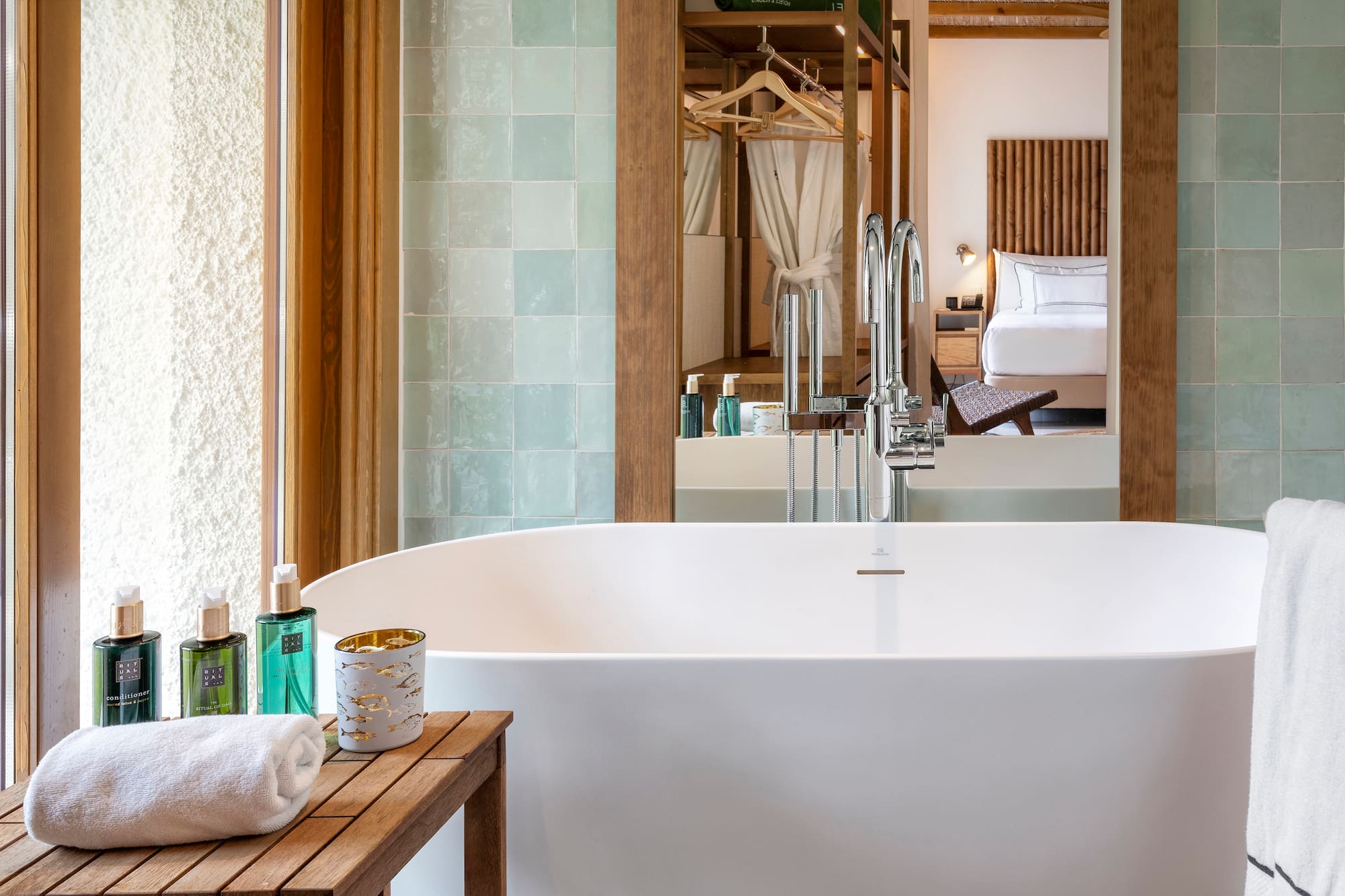 a bathroom with a bathtub and a mirror