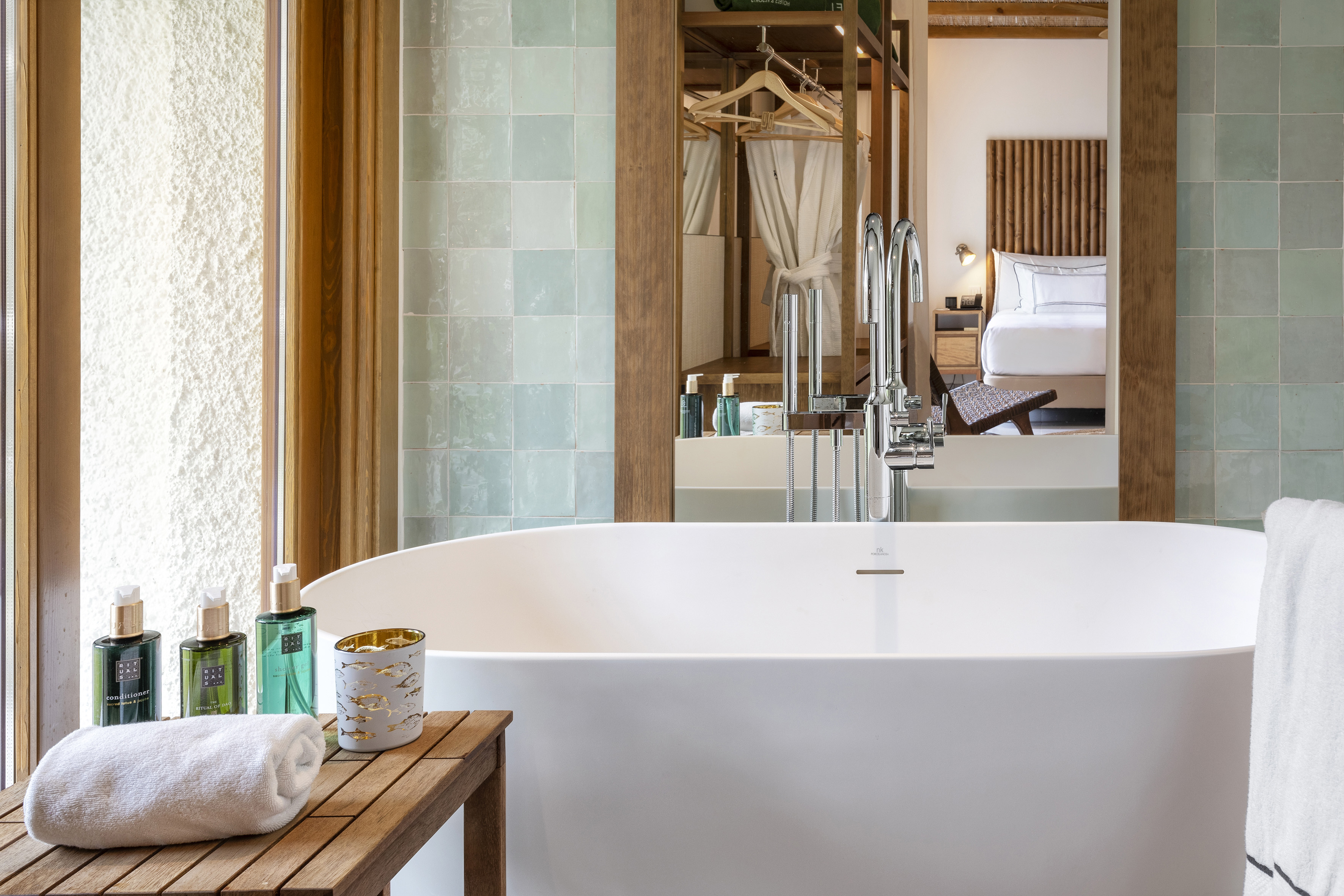 a bathroom with a bathtub and a mirror