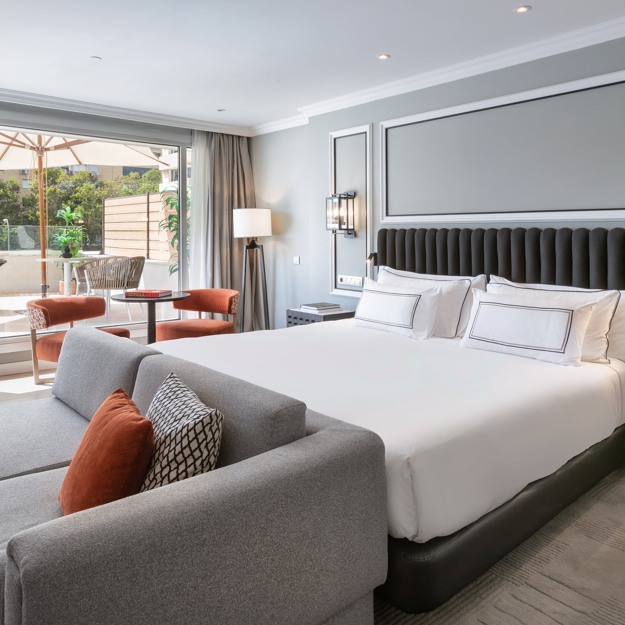 a bedroom with a large bed and a couch