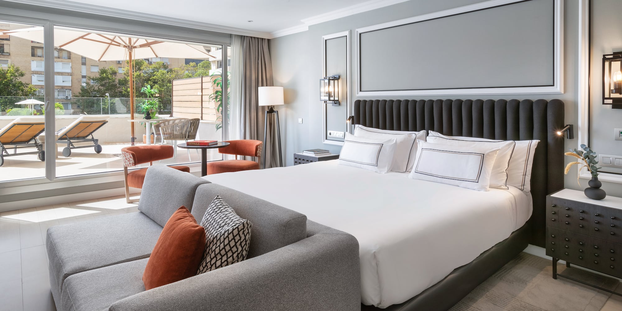 a bedroom with a large bed and a couch