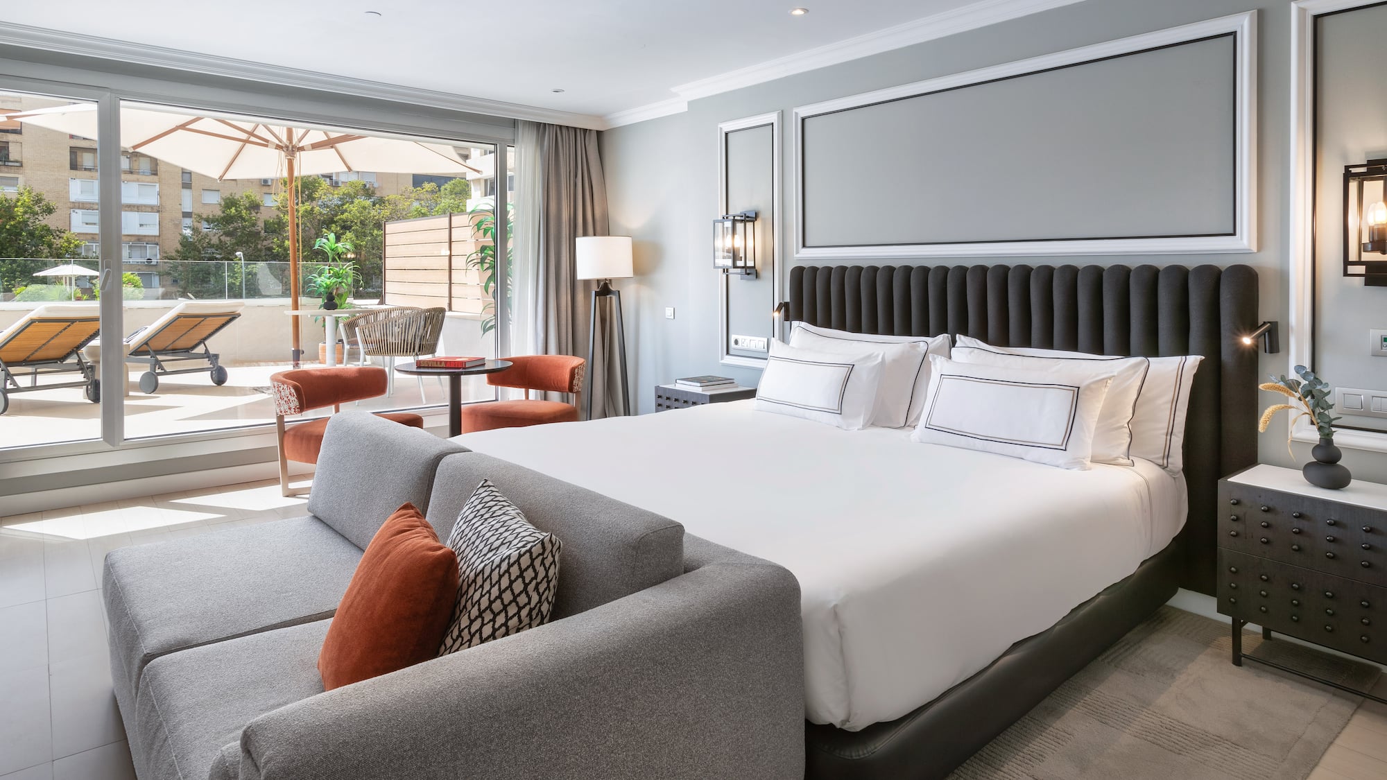 a bedroom with a large bed and a couch