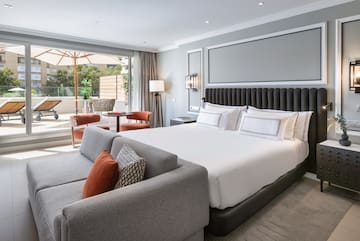 a bedroom with a large bed and a couch