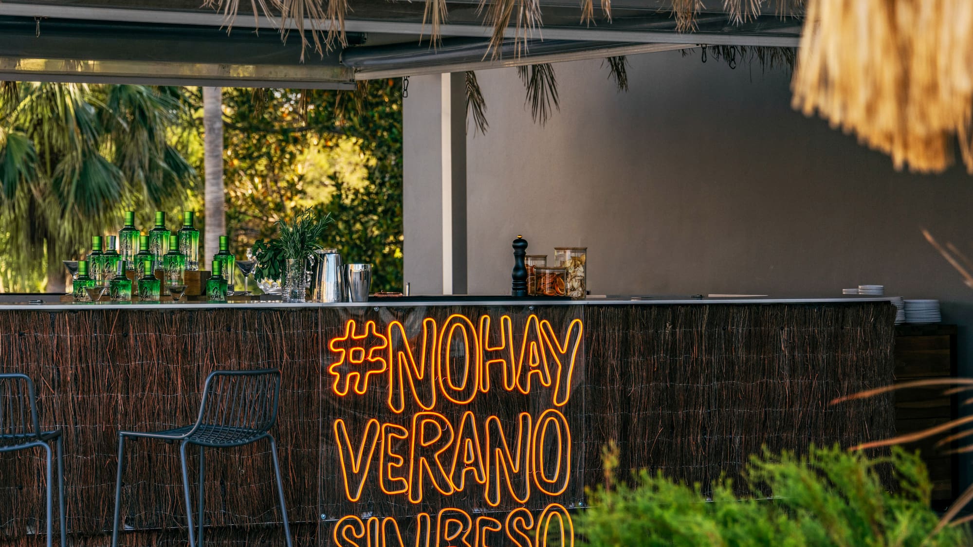 a bar with chairs and a sign
