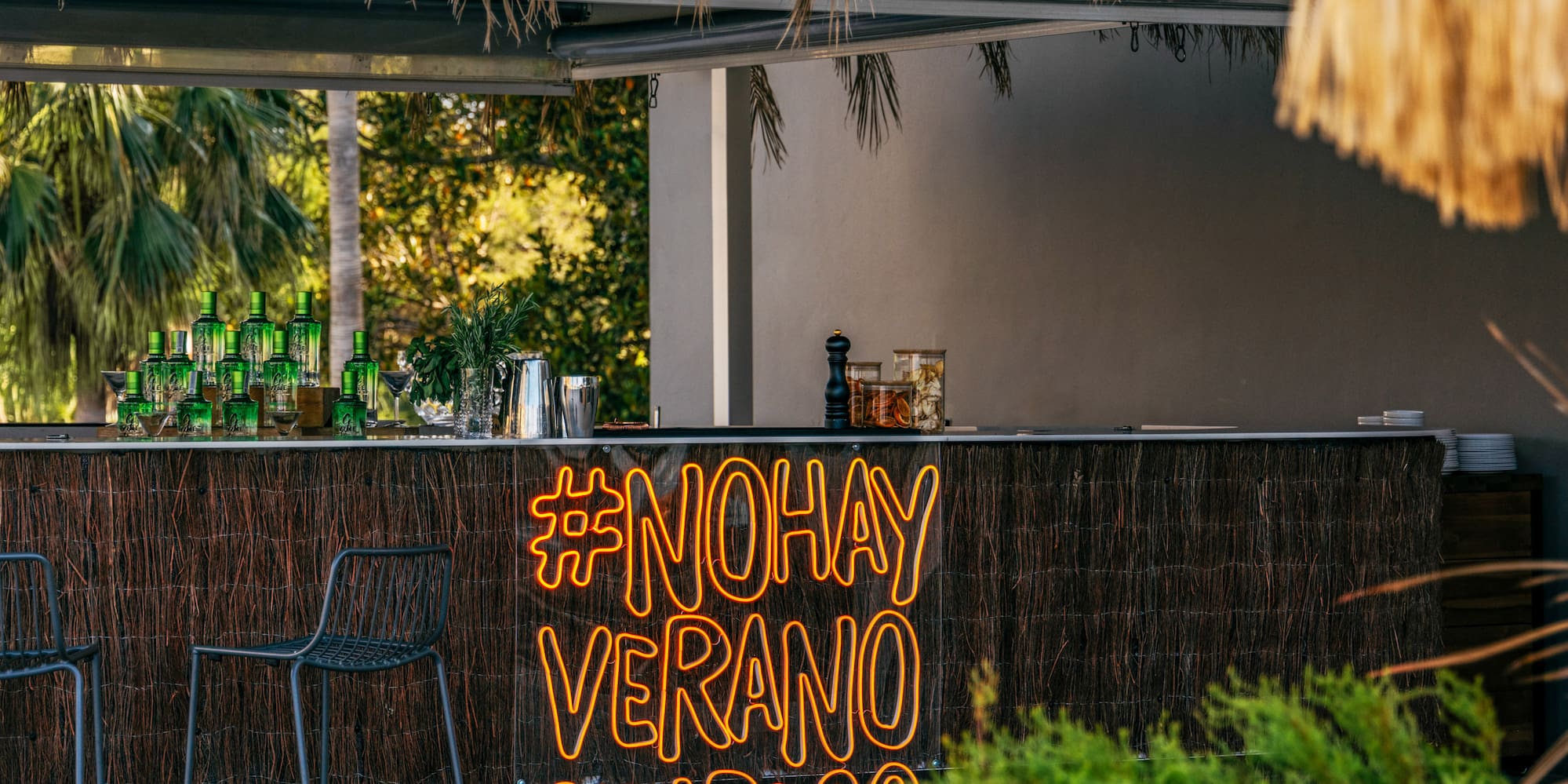 a bar with chairs and a sign