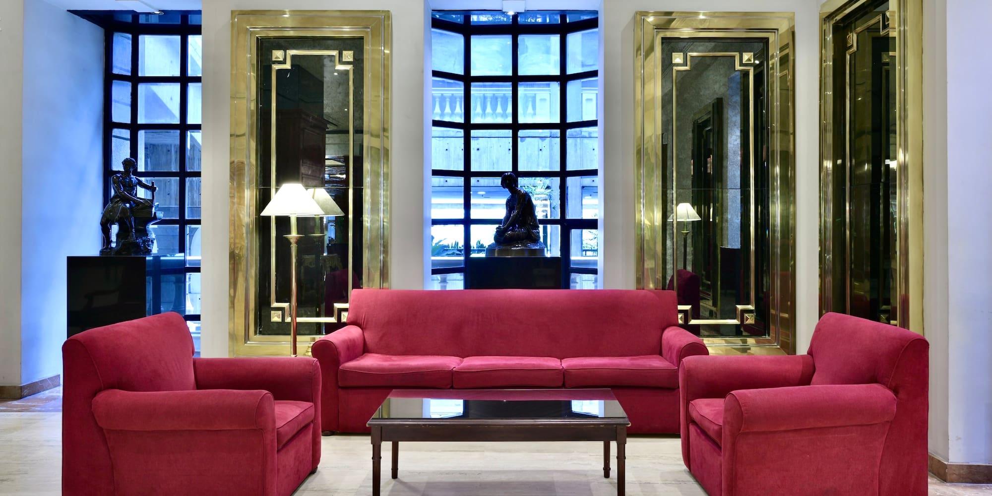 a room with red couches and chairs