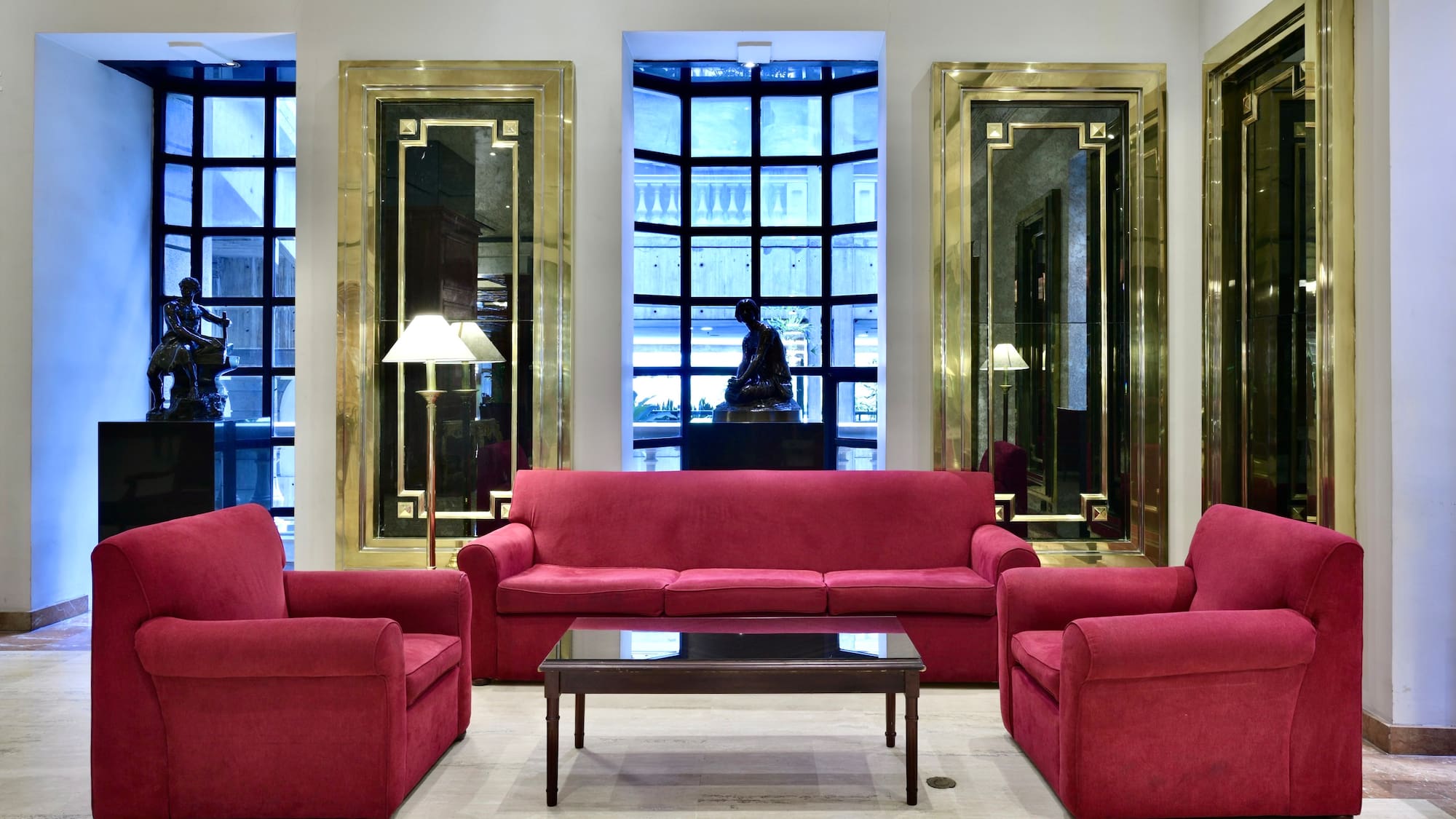a room with red couches and chairs