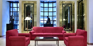 a room with red couches and chairs