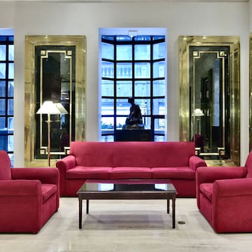 a room with red couches and chairs