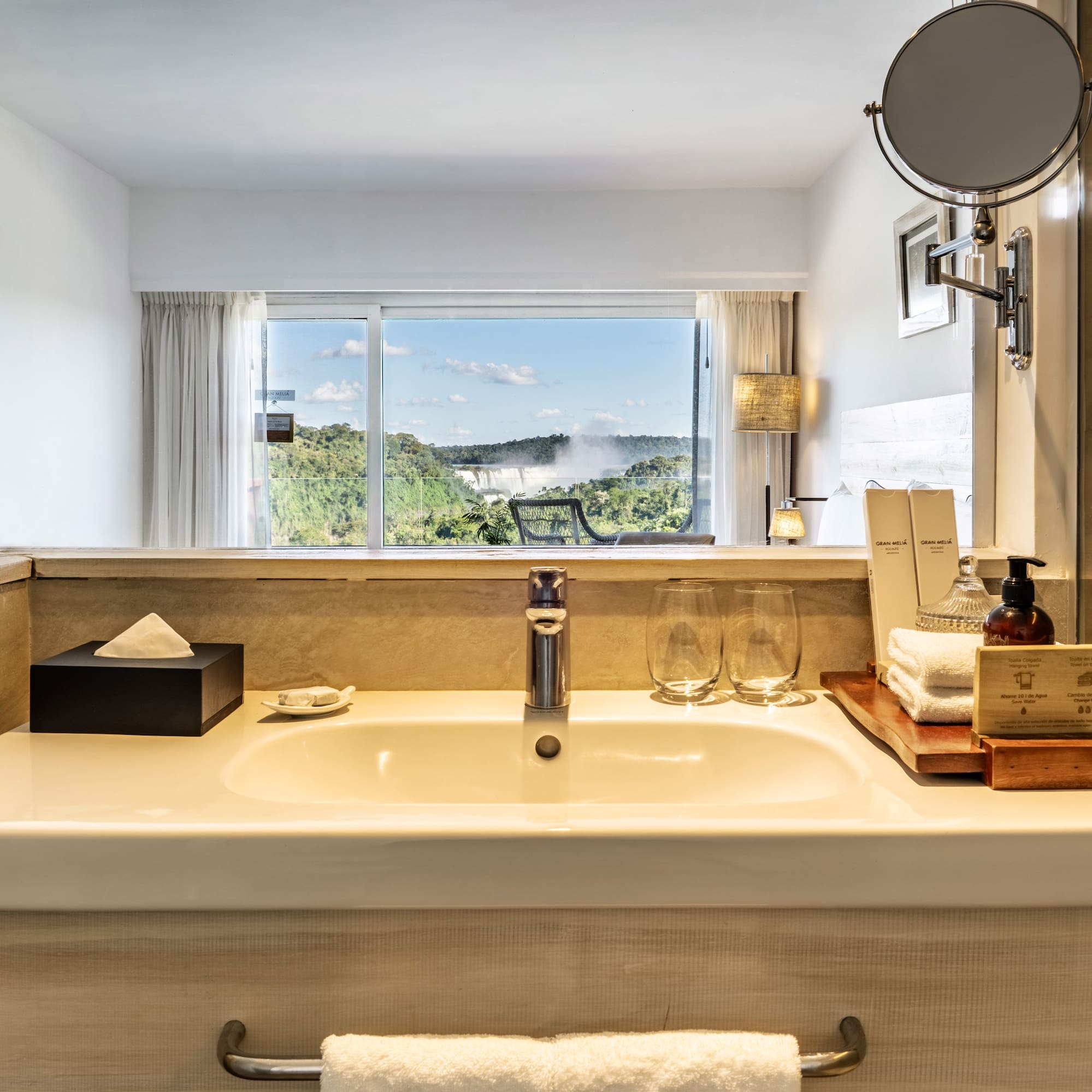 a bathroom sink with a mirror and a window