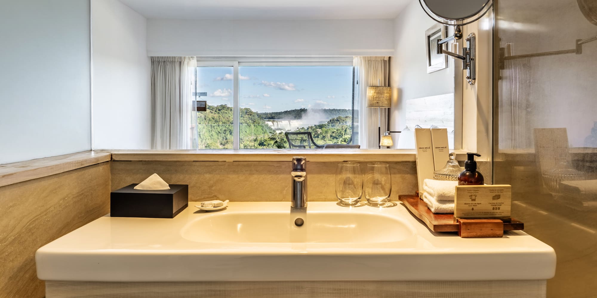 a bathroom sink with a mirror and a window