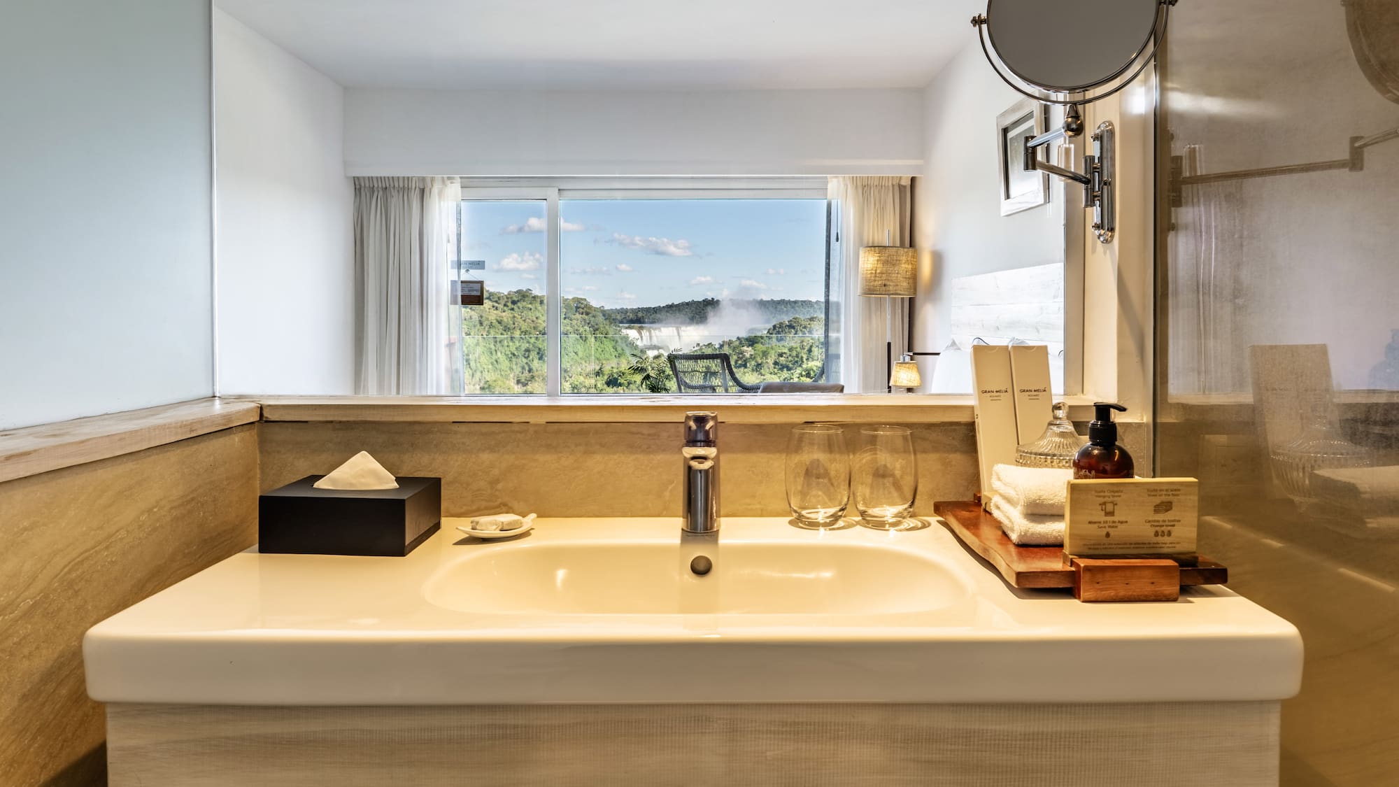 a bathroom sink with a mirror and a window