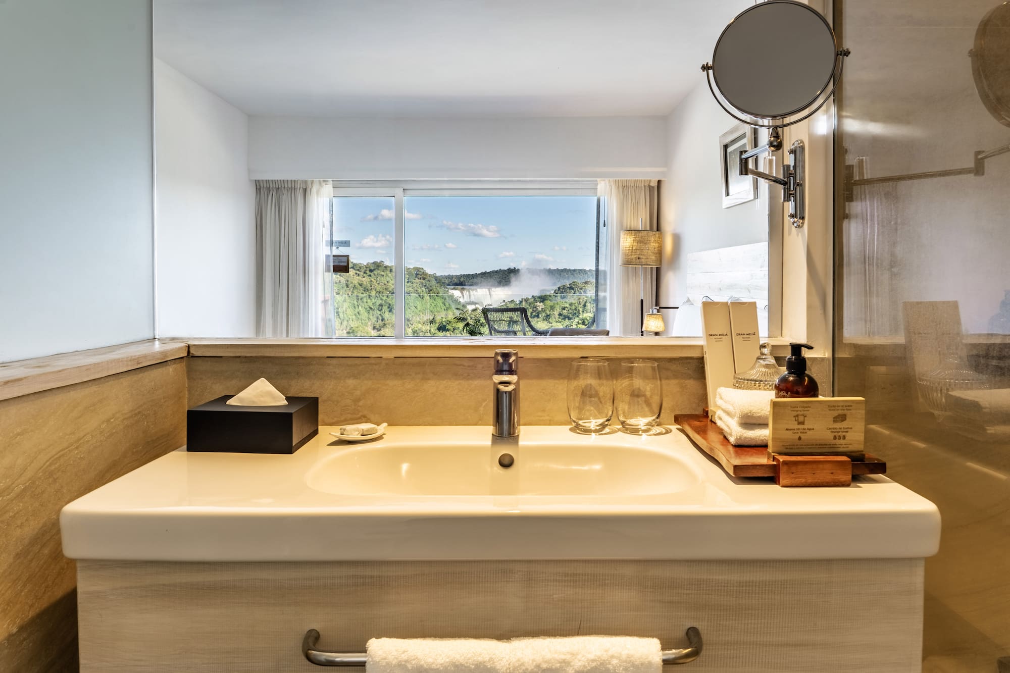 a bathroom sink with a mirror and a window