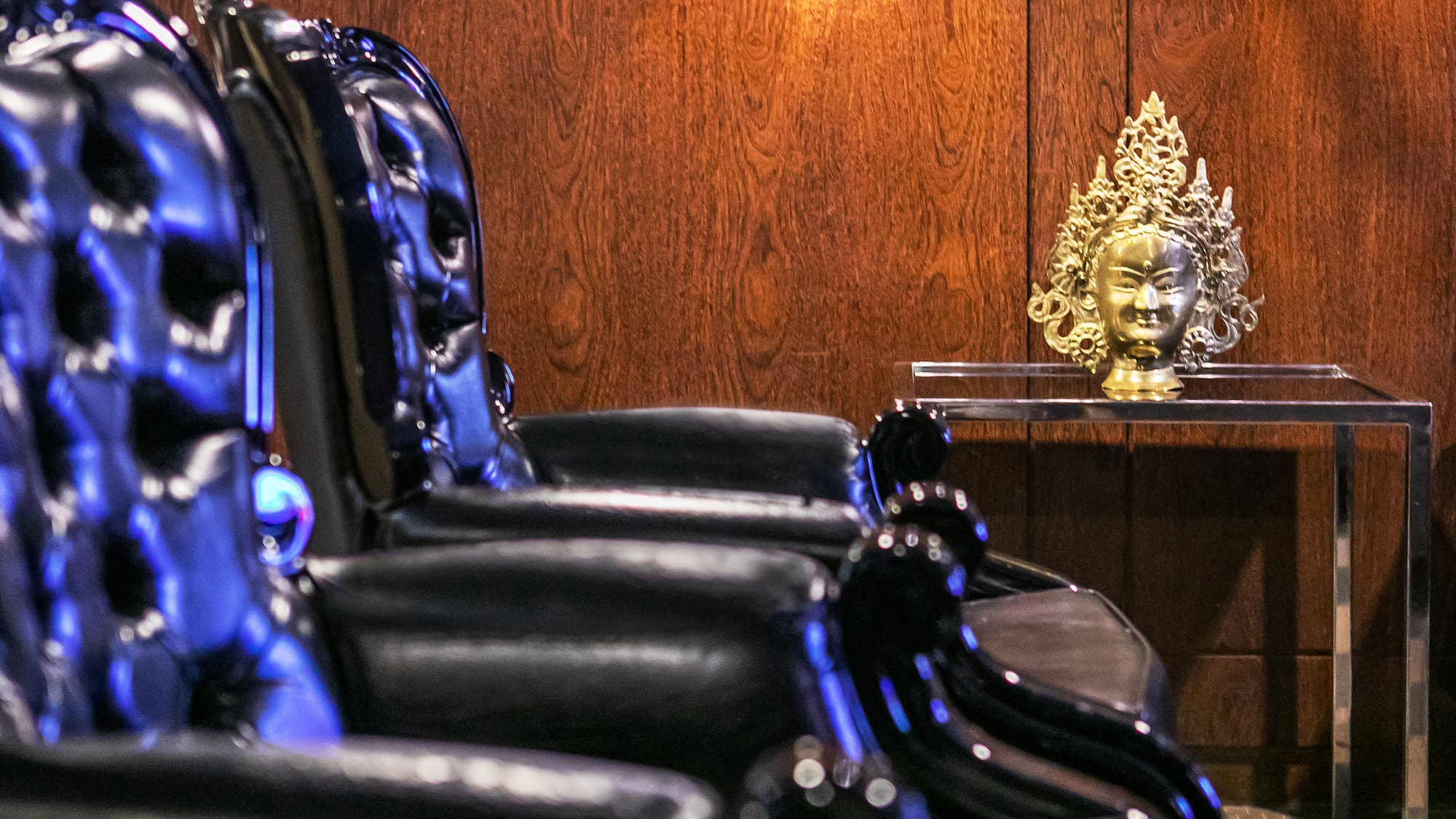 a chair with a gold head on a table