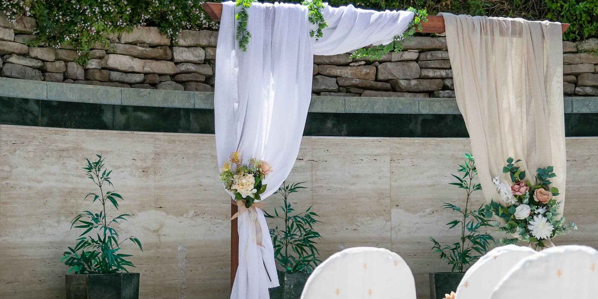 chairs with white cloths and red bows