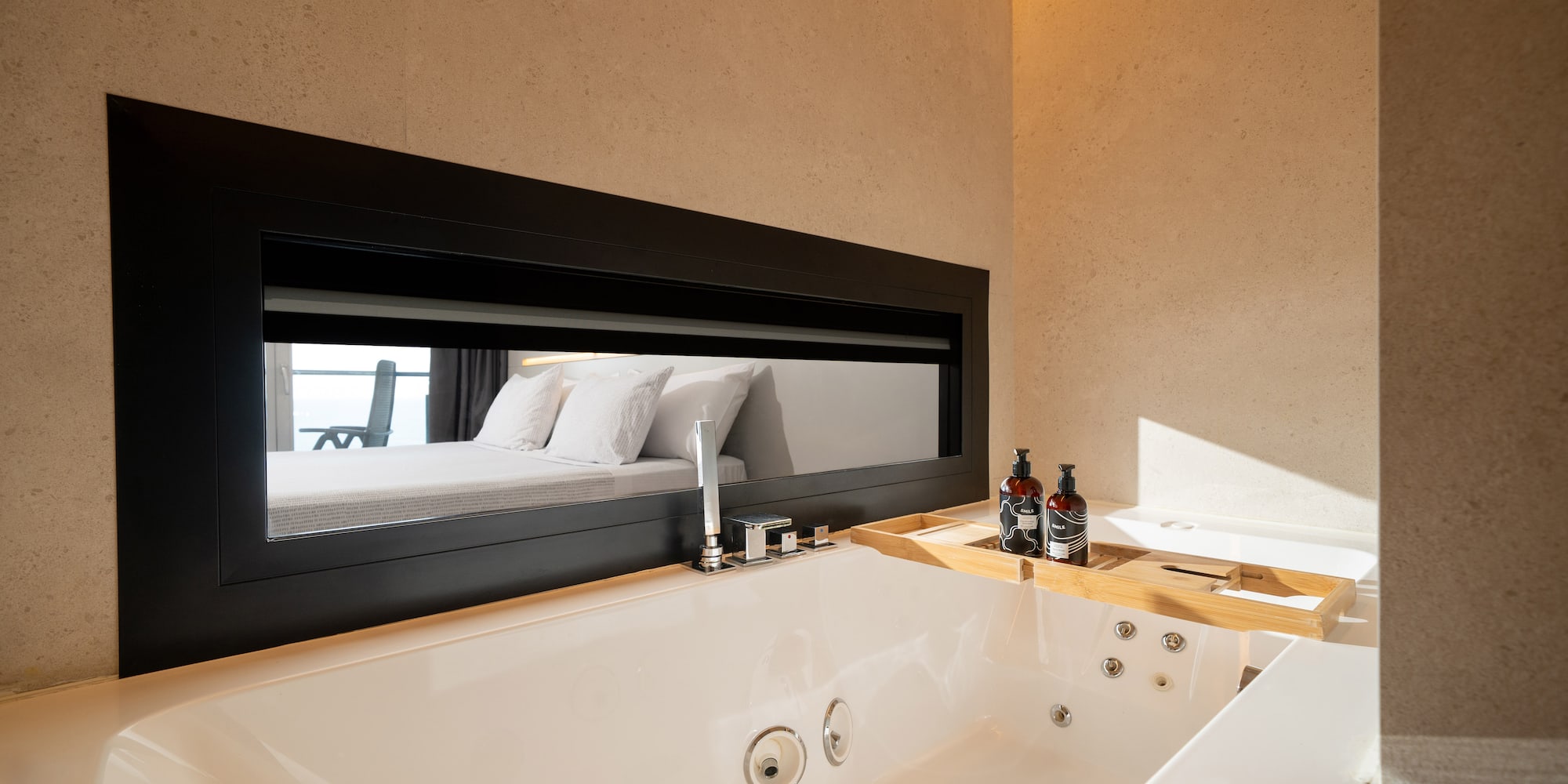 a bathtub and mirror in a bathroom