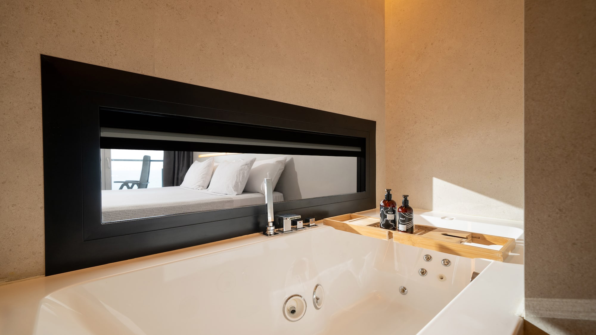 a bathtub and mirror in a bathroom