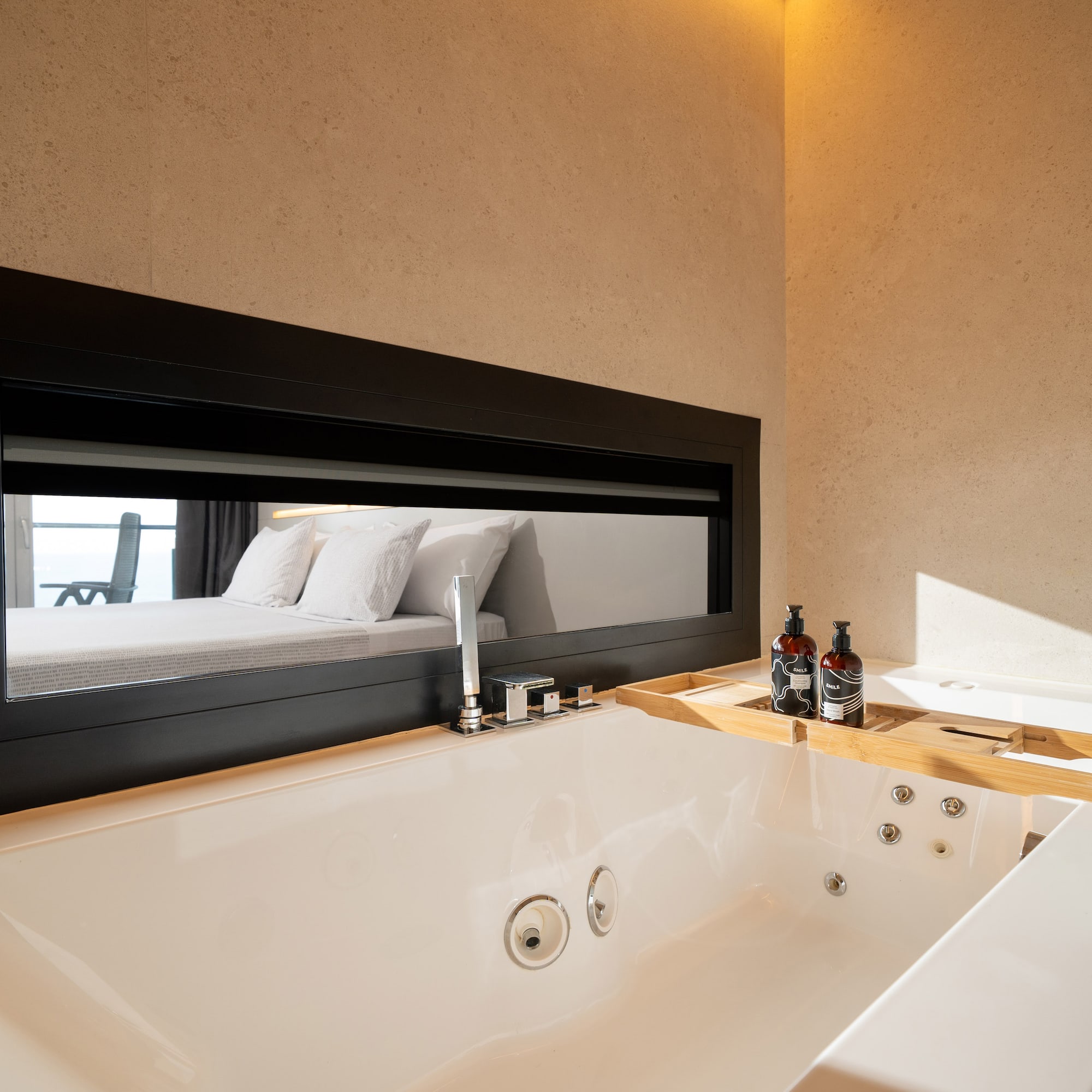 a bathtub and mirror in a bathroom