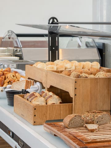 a buffet table with bread and rolls