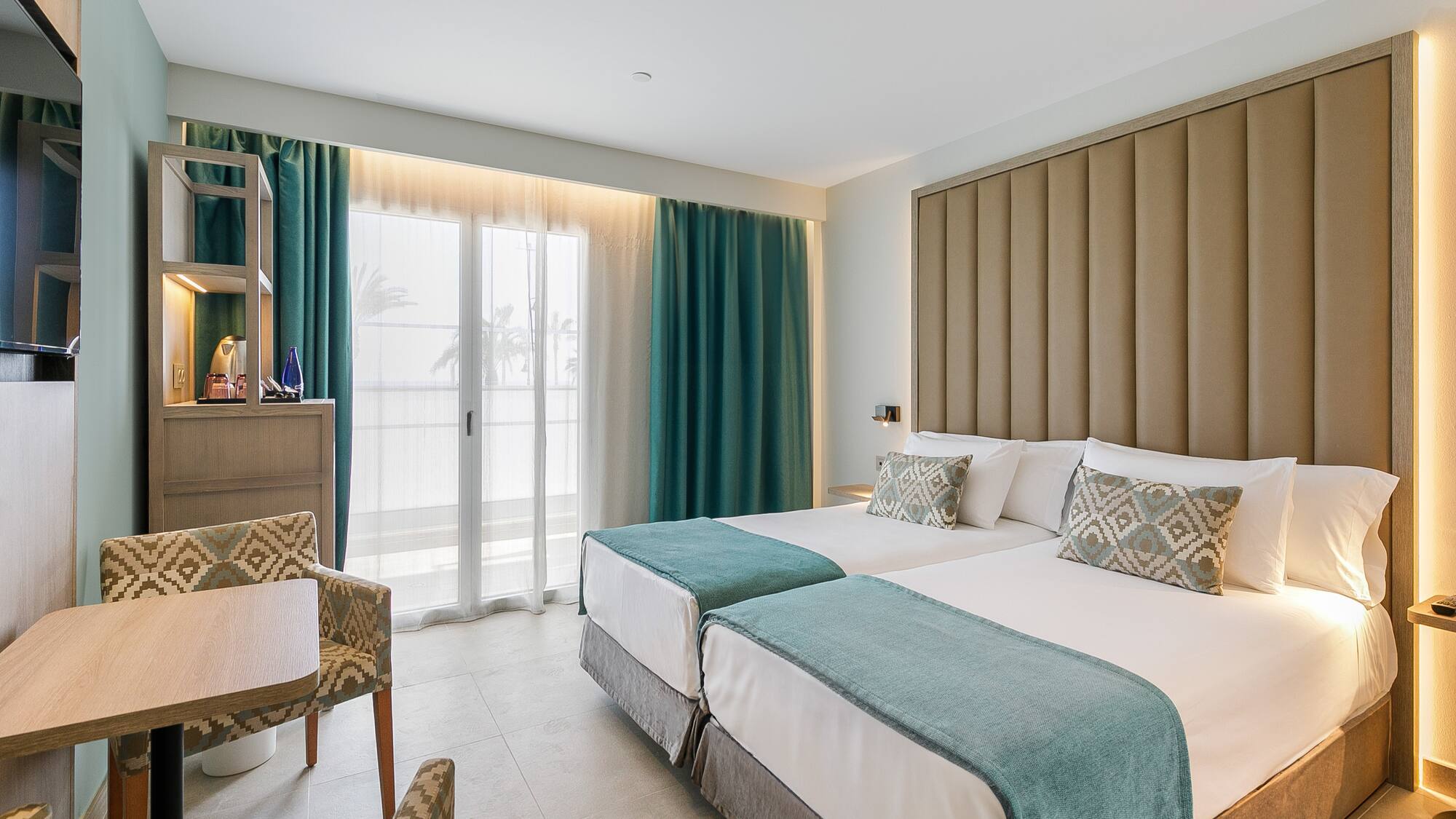 a room with two beds and a chair