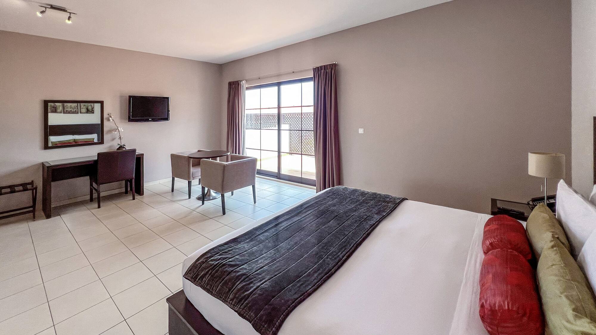 a room with a bed and a television