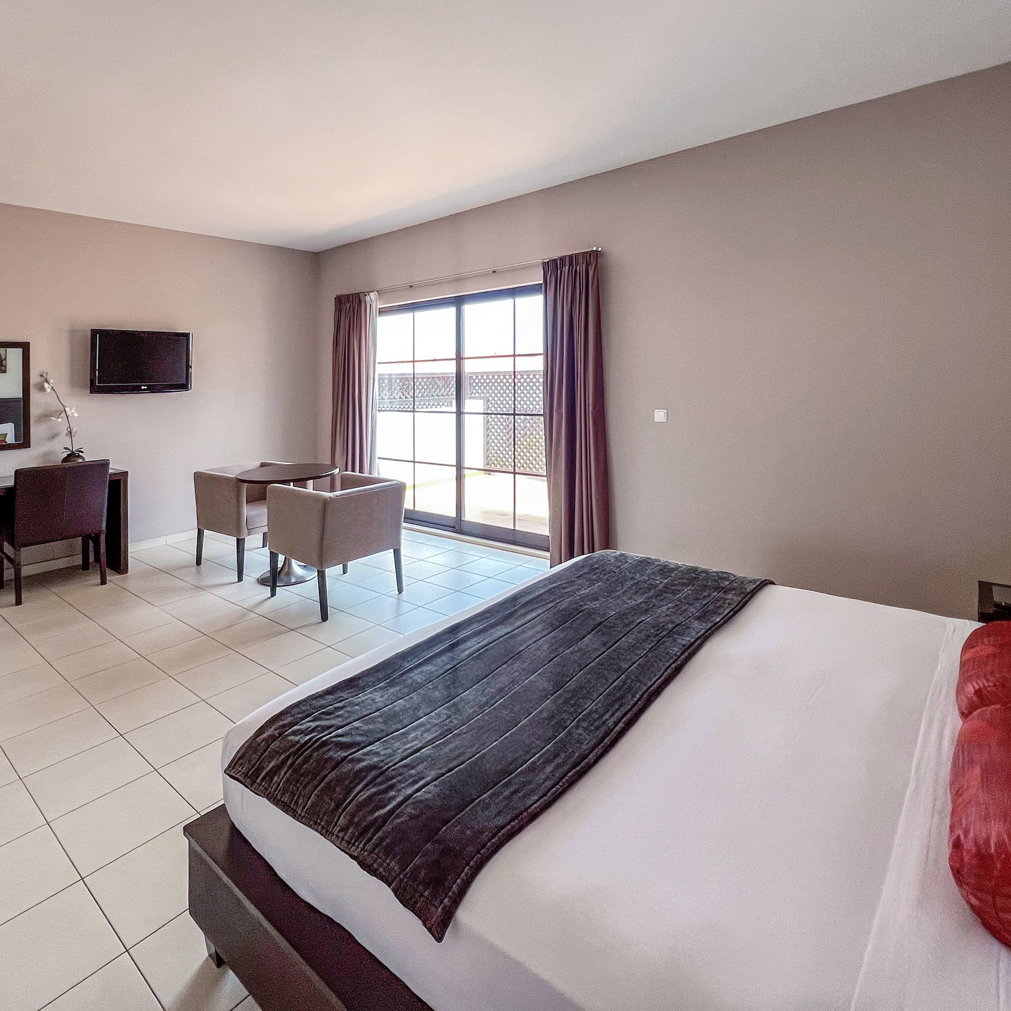 a room with a bed and a television