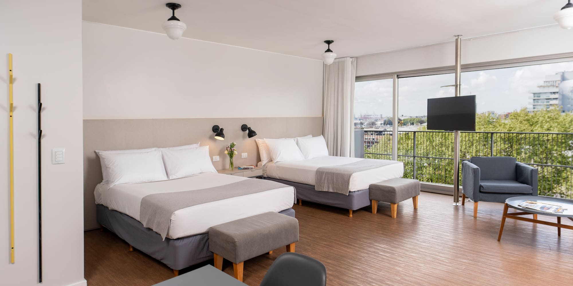 a room with two beds and a television