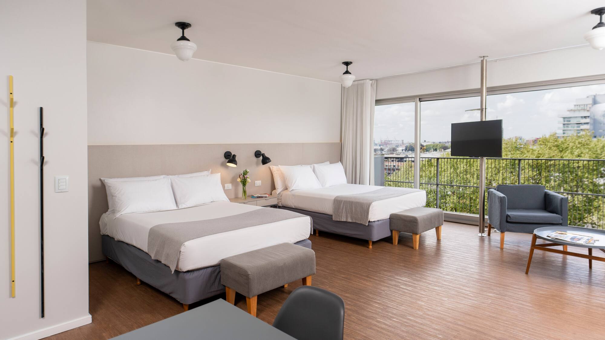 a room with two beds and a television