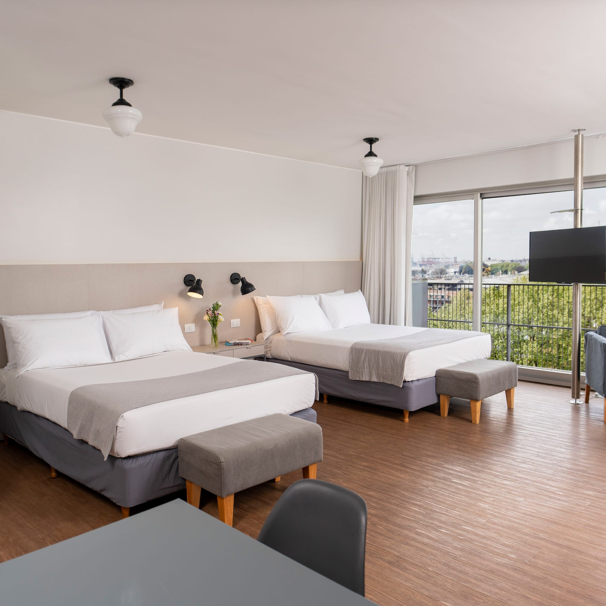 a room with two beds and a television