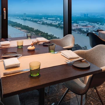 a table with chairs and a view of a city