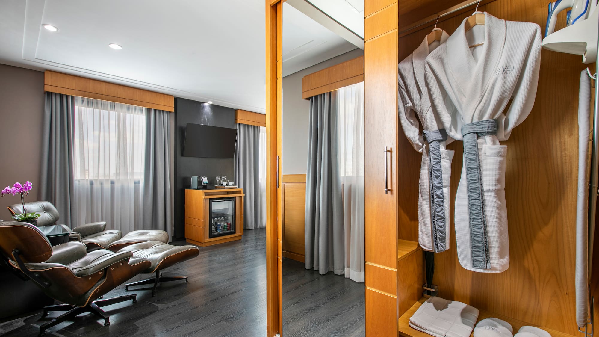 a room with a mirror and a robe from a swinger