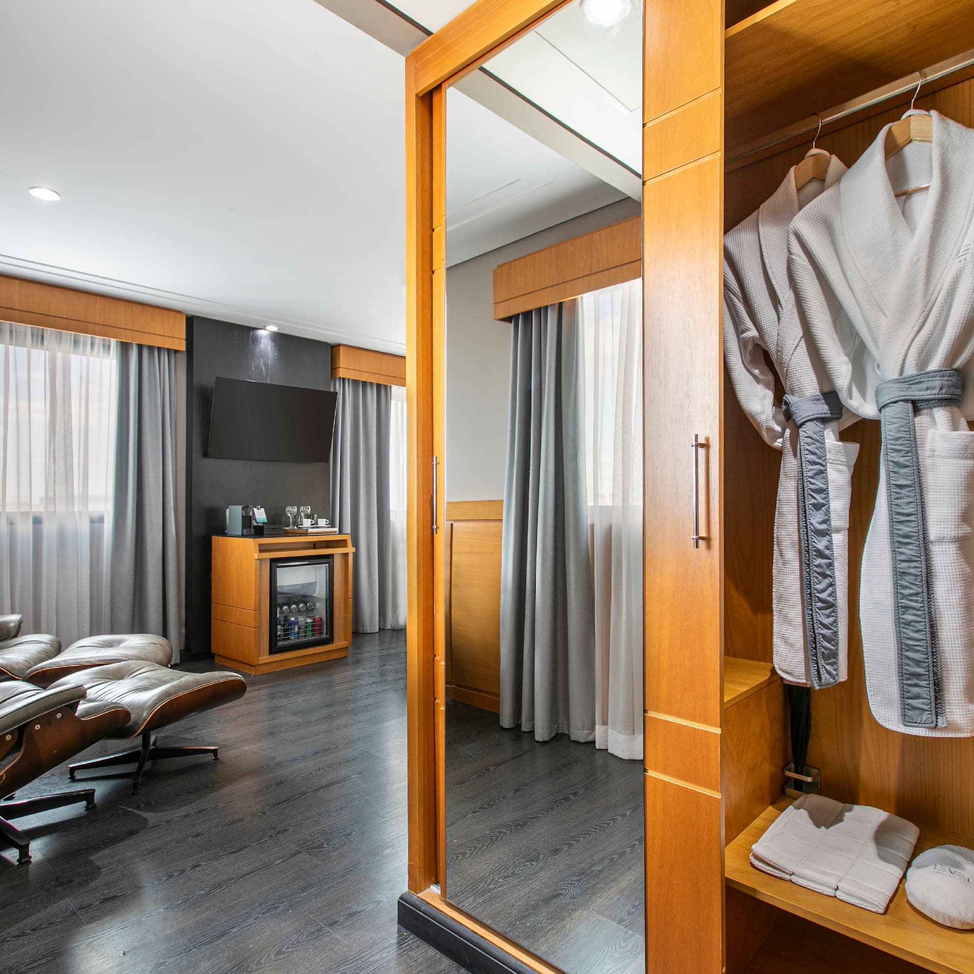 a room with a mirror and a robe from a swinger