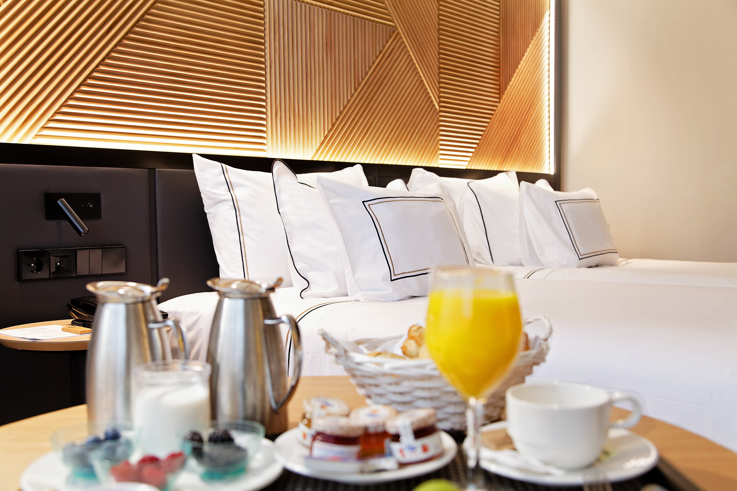 Hotel room service breakfast: juice, coffee, pastries, and berries.