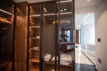 a closet with glass doors and shelves